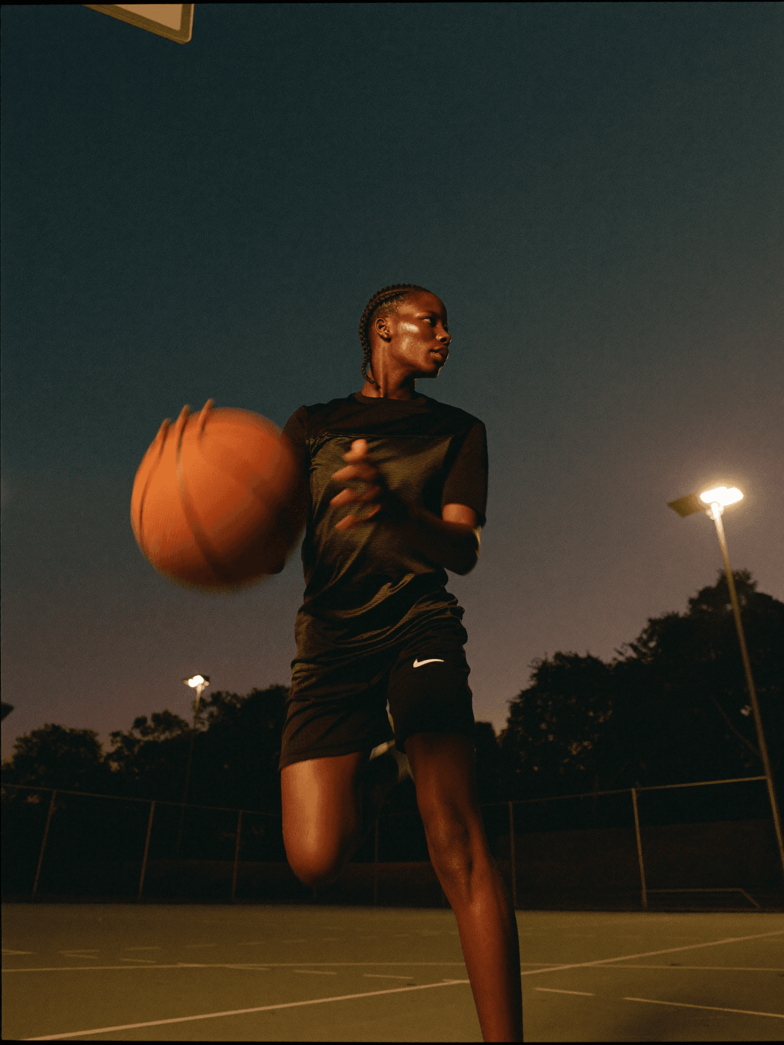 Basketball athlete mid jump-shot at dusk, representing NLR’s nationwide recruiting coverage